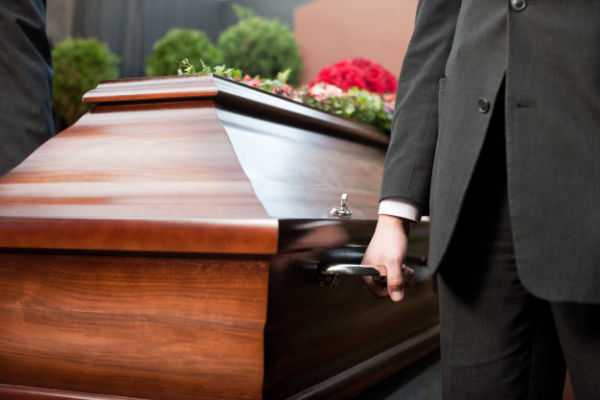 coffin bearer carrying casket funeral