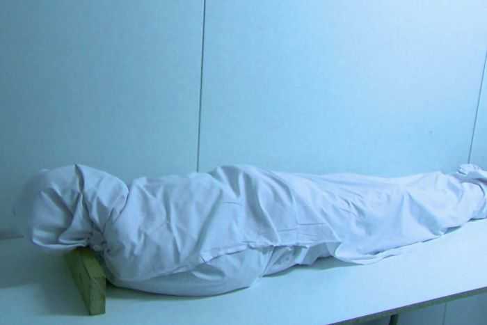 Body wrapped in white cloth image